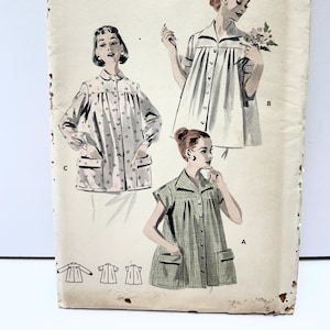 May include: Vintage Butterick printed sewing pattern, size 14, featuring illustrations of three different shirt designs. The cover shows a bust size of 32 inches. The pattern includes designs with pockets and various sleeve lengths.