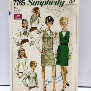May include: Simplicity sewing pattern number 7765 for a blouse and dress. The pattern is for a size 16, bust 38. The pattern is from 1965 and includes instructions for making a blouse with a ruffled collar and a plaid dress with a vest.