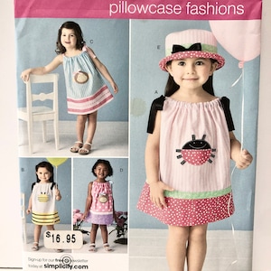 May include: Simplicity sewing pattern number 2383 for pillowcase fashions. The pattern includes five different designs for children's dresses. The dresses feature various colors and patterns, including pink, blue, yellow, and white. The pattern is for sizes 1/2, 1, 2, 3, and 4.