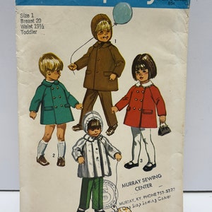 May include: A vintage Simplicity sewing pattern for children's coats. The pattern is for sizes 1-3 and includes three different styles: a brown coat with a hood, a green coat with a collar, and a red coat with a collar. The pattern is titled "9042 Simplicity 75c" and includes instructions for sewing the coats.