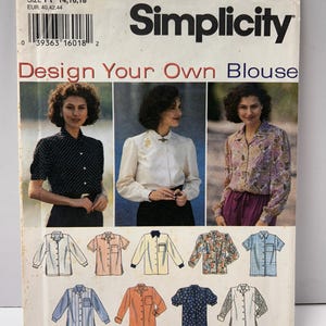 May include: A vintage Simplicity sewing pattern for a blouse, featuring the text "Design Your Own Blouse." The pattern includes images of different blouse styles and the size range 14, 16, 18.