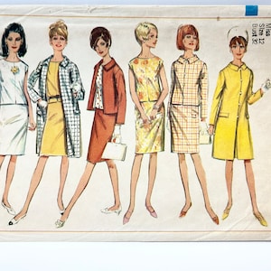May include: Vintage Simplicity sewing pattern number 6882 for a dress with a bust size of 32. The pattern features five different dress styles, including a yellow dress with a white collar, a yellow dress with a black belt, a red dress with a white collar, a yellow dress with a floral print, and a plaid dress with a white collar.