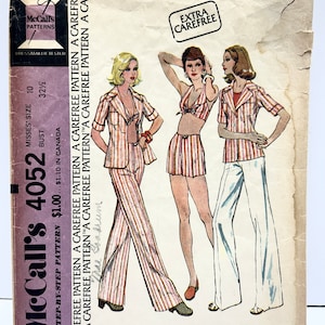 May include: A vintage sewing pattern for a shirt-jacket, top, and pants. The pattern is for misses' sizes 10-12 and features a striped design. The pattern is from McCall's and is labeled "Extra Carefree".