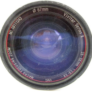 May include: A black Vivitar Series 1 Macro Focusing Zoom lens with a 67 mm filter thread. The lens is a 28-105 mm, 1:2.8-3.8.