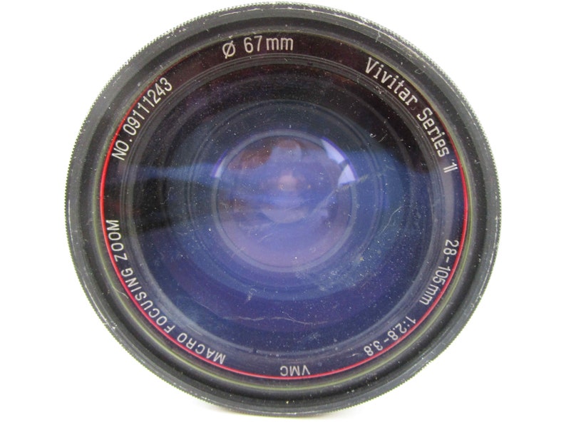 May include: A black Vivitar Series 1 Macro Focusing Zoom lens with a 67 mm filter thread. The lens is a 28-105 mm, 1:2.8-3.8.