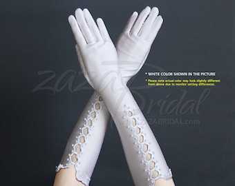 May include: A pair of white satin elbow-length gloves with a delicate pearl and lace design. The gloves have a scalloped edge and are shown crossed over each other.