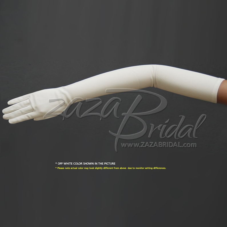 May include: A pair of long, off-white satin gloves. The gloves are shown on a model's arm, bent at the elbow. The gloves extend to the elbow and cover the entire hand. The gloves are smooth and have a slight sheen. * OFF WHITE COLOR SHOWN IN THE PICTURE *Please note actual color may look slightly different from above due to monitor setting differences.