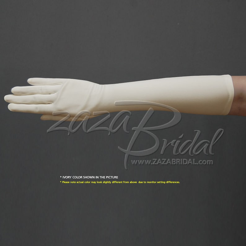 May include: Ivory long satin gloves, extending to the elbow. The gloves are shown on a hand, with the fingers extended. The text "Zaza Bridal" and "www.ZAZABRIDAL.com" is visible below the hand. The text "IVORY COLOR SHOWN IN THE PICTURE" is visible below the text. The text "Please note actual color may look slightly different from above due to monitor setting differences." is visible below the text.