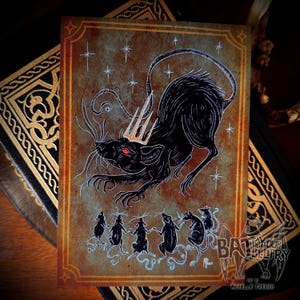 May include: A rectangular art print featuring a large black rat with a gold crown and red eyes, surrounded by smaller rats in a circle. The background is a textured, weathered brown with white star accents and a decorative border. Text reads BAT IN YOUR BELFRY.
