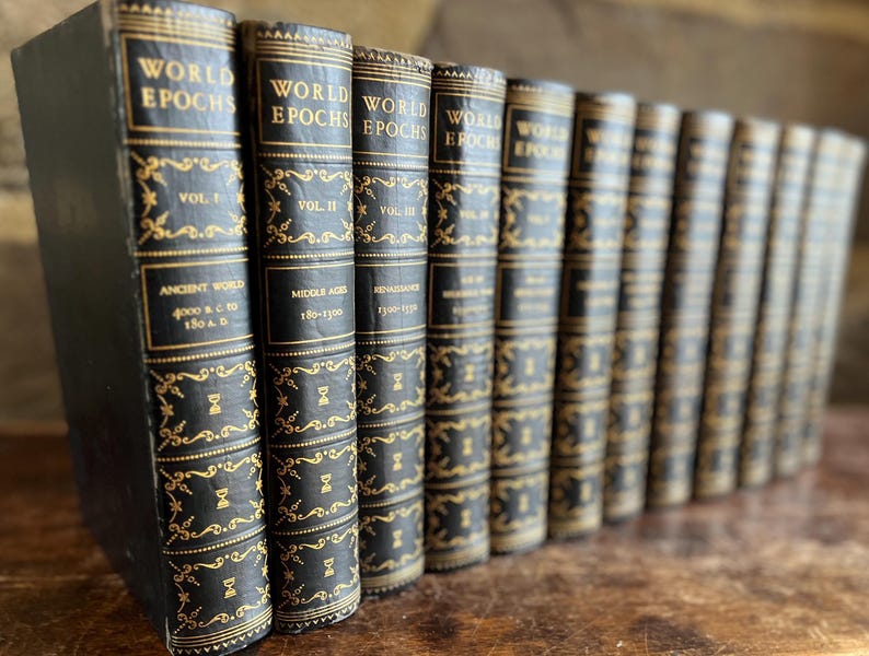 May include: A collection of antique books titled "World Epochs" with black covers and gold lettering. The spines display volume numbers and historical periods like "Ancient World" and "Middle Ages." The books are arranged in a row, suggesting a historical or literary theme.