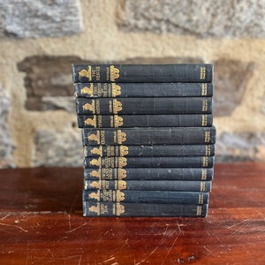 May include: A stack of 14 black hardcover books with gold lettering on the spines. The titles include "Lord Jim", "An Outcast of the Islands", "The Nigger of the Narcissus", "Typhoon", "Nostromo", "The Mirror of the Sea", and "The Rescue".