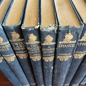 May include: A set of ten vintage hardcover books with gold lettering on black spines. The titles include "Mayer's Folly", "Twix Land and Sea", "The Nigger of the Narcissus", "A Personal Record", "Chance", and "Typhoon".