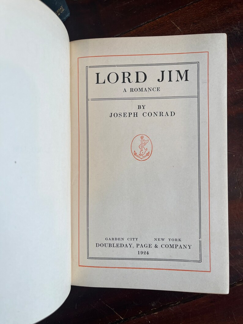 May include: A vintage book cover with the title "LORD JIM" in bold black font. The book is a romance by Joseph Conrad and was published by Doubleday, Page & Company in 1924.