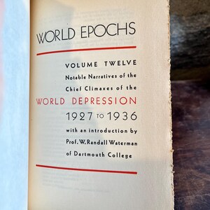 May include: Open book with the title "WORLD EPOCHS" in black font. The text "VOLUME TWELVE" and "WORLD DEPRESSION 1927 TO 1936" are also visible. The book's pages are aged with a slightly yellowed tone.