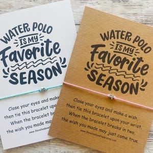 May include: Two cards with the text "Water Polo is my favorite season" printed on them. Each card has a string bracelet attached with a silver star charm. The cards have instructions for making a wish with the bracelet.