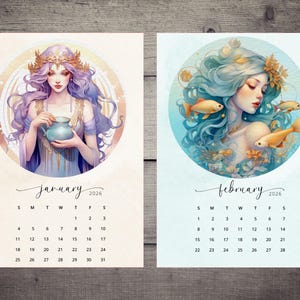May include: Two watercolor art prints of a calendar for 2026. The January print features a woman with purple hair and a crown holding a blue vase. The February print shows a woman with blue hair and gold fish.