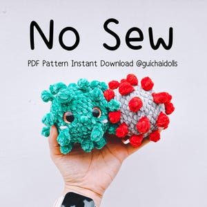 May include: Two plush crochet toys, one teal and one grey with red accents, featuring large dark eyes. The text 'No Sew' and 'PDF Pattern Instant Download @guichaidolls' is displayed above the toys against a plain white background.