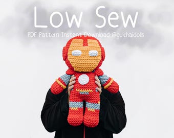 May include: A handmade, crocheted Iron Man doll in red, yellow, and blue. The doll features a helmet, chest emblem, and details mimicking the superhero's suit. The text "Low Sew" and pattern details are visible in the image.