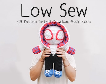 May include: A handmade crochet doll in a superhero costume. The doll has a white body with a red and blue hood, black pants, and blue shoes. The text "Low Sew" and other text are at the top.
