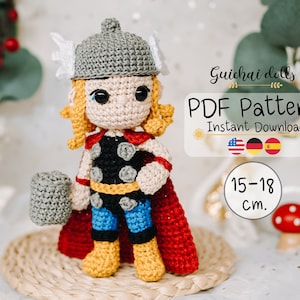May include: Crochet pattern for a Thor doll, 15-18 cm tall. The doll is wearing a red cape, a black and yellow shirt, and blue pants. The doll is holding a grey hammer.