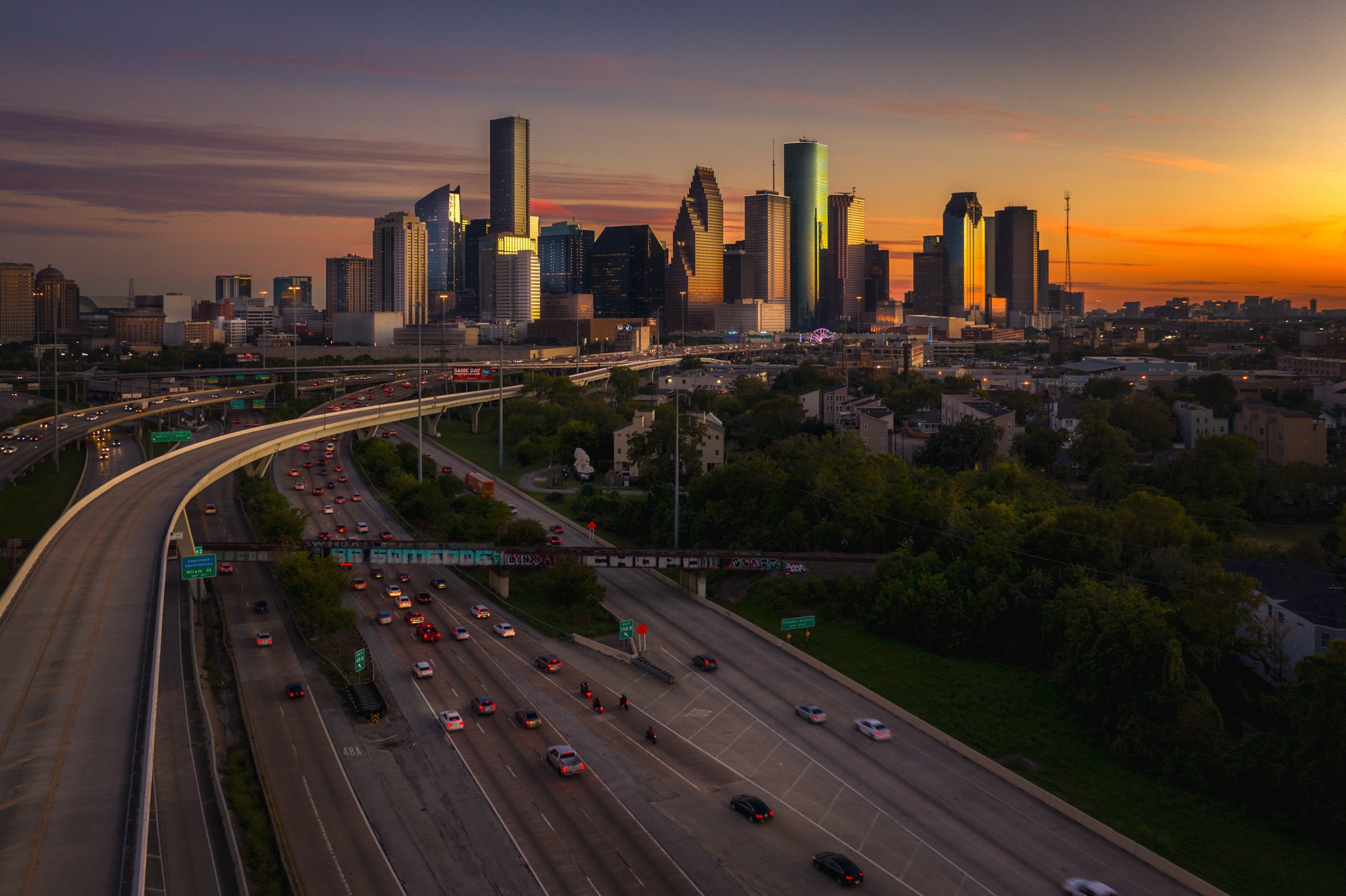 Aerial View of Downtown Houston Skyline and Be Someone Mural at Sunset