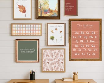 May include: A collection of framed art prints with a fall theme, including watercolor illustrations of leaves, an autumn landscape, and an acorn life cycle. One print displays the alphabet. The frames are various sizes and colors.