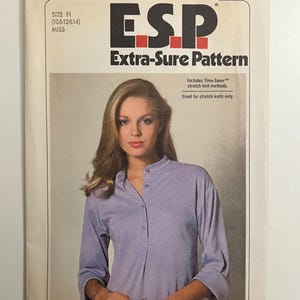 May include: Simplicity pattern number 9025, an Extra-Sure Pattern for stretch knits, featuring a long-sleeved shirt with a button-up front and a mandarin collar. The pattern is for sizes N (10, 12, 14) for misses.