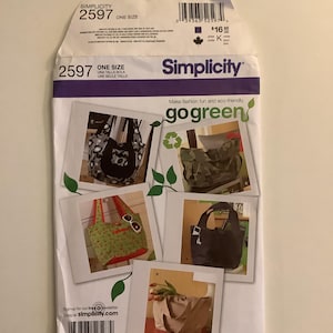 May include: A Simplicity sewing pattern envelope, featuring images of various tote bags. The envelope is white with purple accents and includes the text "Simplicity" and "go green". The pattern number is 2597, and it is labeled "one size".