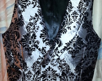 Six button double-breasted vest of gray taffeta damask with black velvet flocking with pointed or  square cut front.