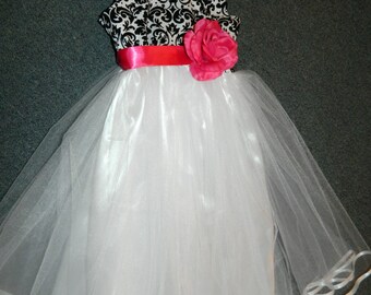 Black and white damask bodice embellished with any color sash/flower attached to billowy white tulle skirt with white satin lining.