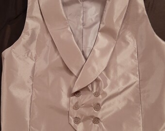 Six button double-breasted vest of silver/ gray taffeta with pointed or square cut front.