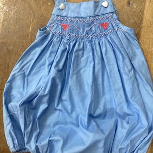 Sunsuit smocked at the front with hearts and hearts buttons on a  baby girl bubble size  6-12 months