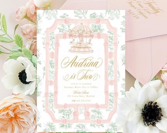 May include: A pink and green invitation with a gold border and a watercolor illustration of a carousel. The invitation reads "Audrina is Two" and includes details for a birthday party. The text "Freshmint Paperie" is at the bottom of the invitation.
