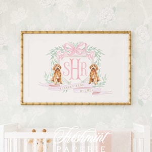 May include: A rectangular wall art print in a gold bamboo-style frame featuring a watercolor crest with a pink bow, green leaves, two golden-brown dogs, the monogram SHR, and the text SCARLET RENE HUGHES printed on a pink ribbon banner.