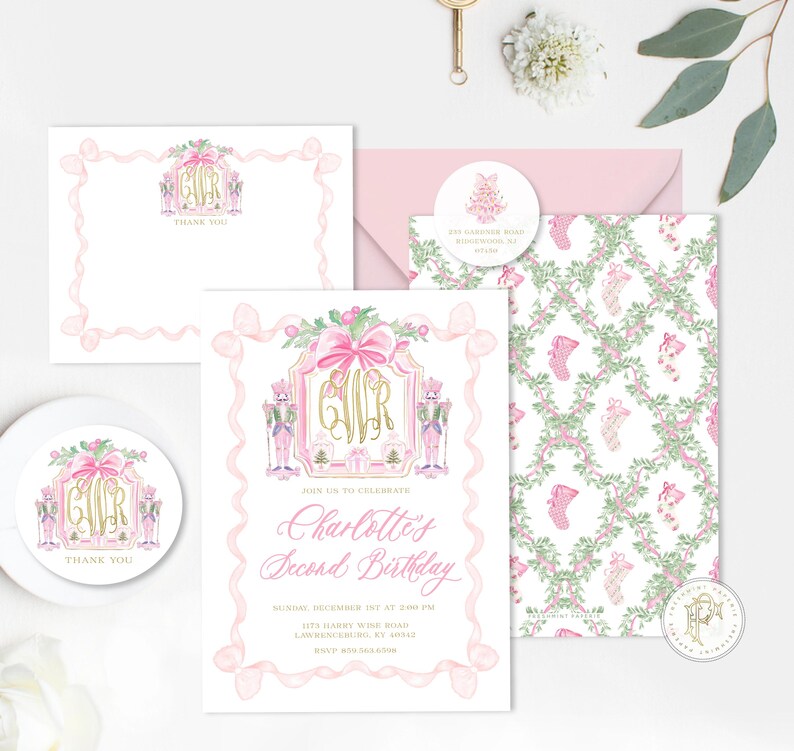 K&ouml;nnte beinhalten: Eine Sammlung von rosa und goldenen Schreibwaren, darunter eine Einladung, eine Dankeskarte, ein Umschlag und ein Aufkleber. Die Einladung tr&auml;gt den Text "Charlotte's Second Birthday" und zeigt Nussknacker, Schleifen und ein Monogramm.