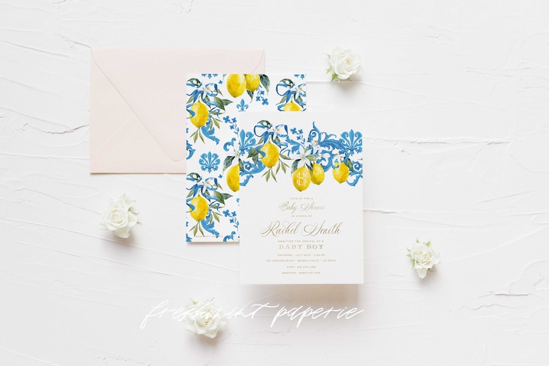 May include: A baby shower invitation with a blue and white tiled pattern featuring lemons and floral accents. The invitation text reads "You're Invited to a Baby Shower" and "Rachel Smith" in gold script. The text "Baby Boy" is in gold block letters.