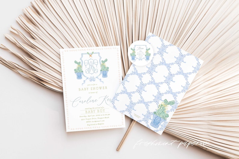 May include: A baby shower invitation with a blue and green floral design. The invitation features a monogram with the initials "CK" and the text "Join us for a Baby Shower in honor of Caroline K. celebrating the arrival of a Baby Boy".