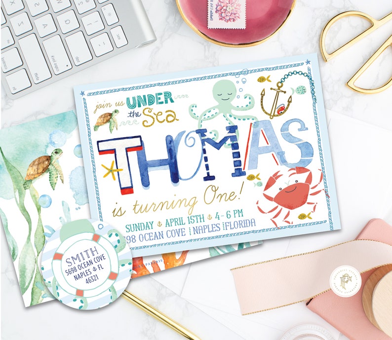 May include: A blue and white invitation card with a nautical theme. The card features the text "join us UNDER the Sea THOMAS is turning One!" with a red, white, and blue star. The card also features illustrations of an octopus, a crab, a turtle, and an anchor.