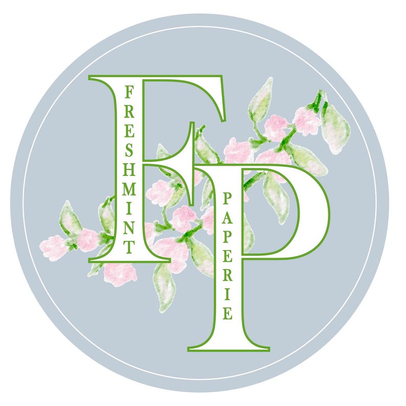 May include: A light blue circle with a white "F" and "P" in the center. The "F" has the word "Freshmint" written vertically down the side. The "P" has the word "Paperie" written vertically down the side. The letters are surrounded by green leaves and pink flowers.