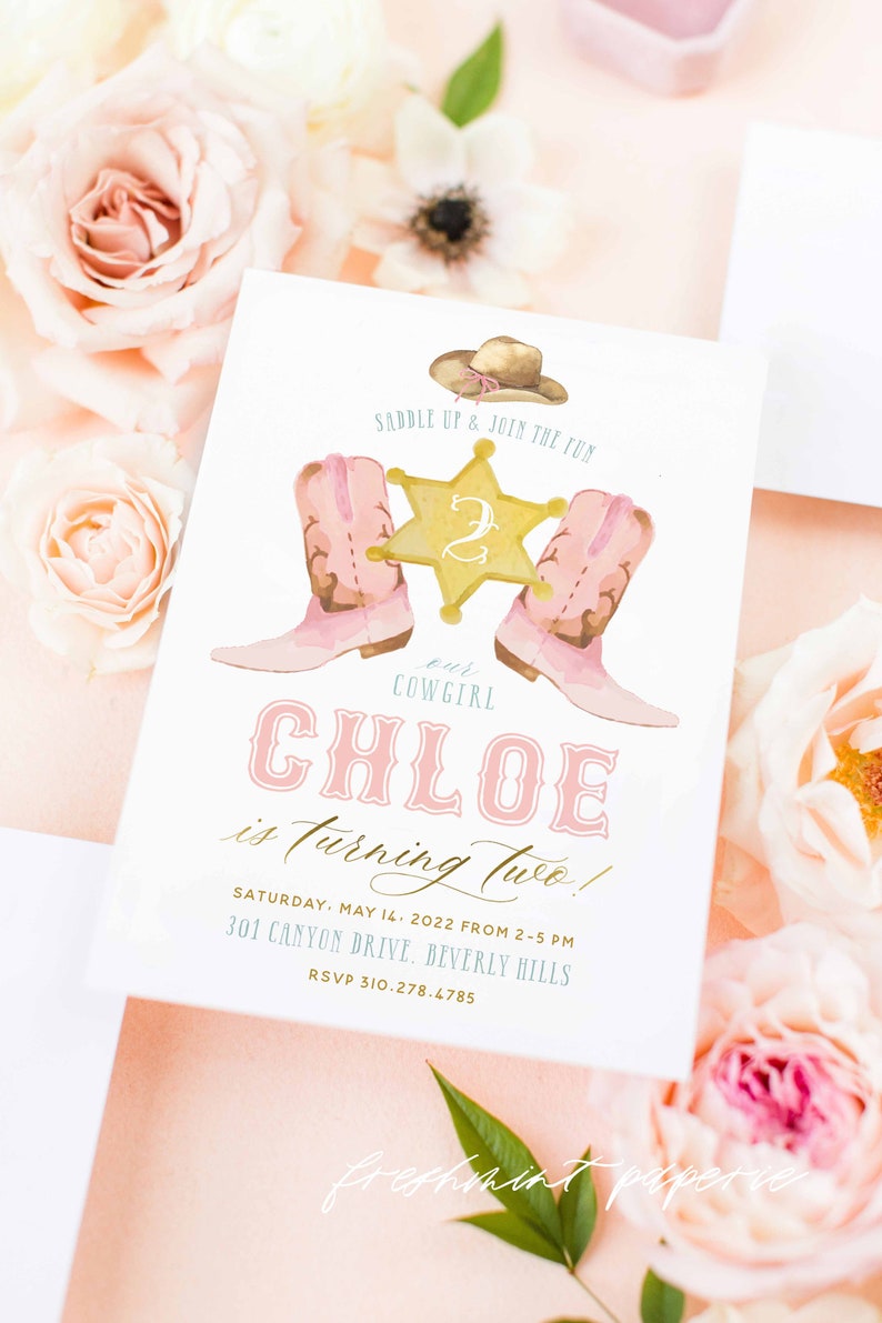 May include: A pink and white invitation with a watercolor illustration of a cowboy hat, two pink boots, and a gold sheriff's star with the number 2 on it. The text reads "Saddle Up & Join the Fun, our Cowgirl Chloe is turning two! Saturday, May 14, 2022 from 2-5 PM, 301 Canyon Drive, Beverly Hills, RSVP 310-278.4785, Freshmint Paperie".