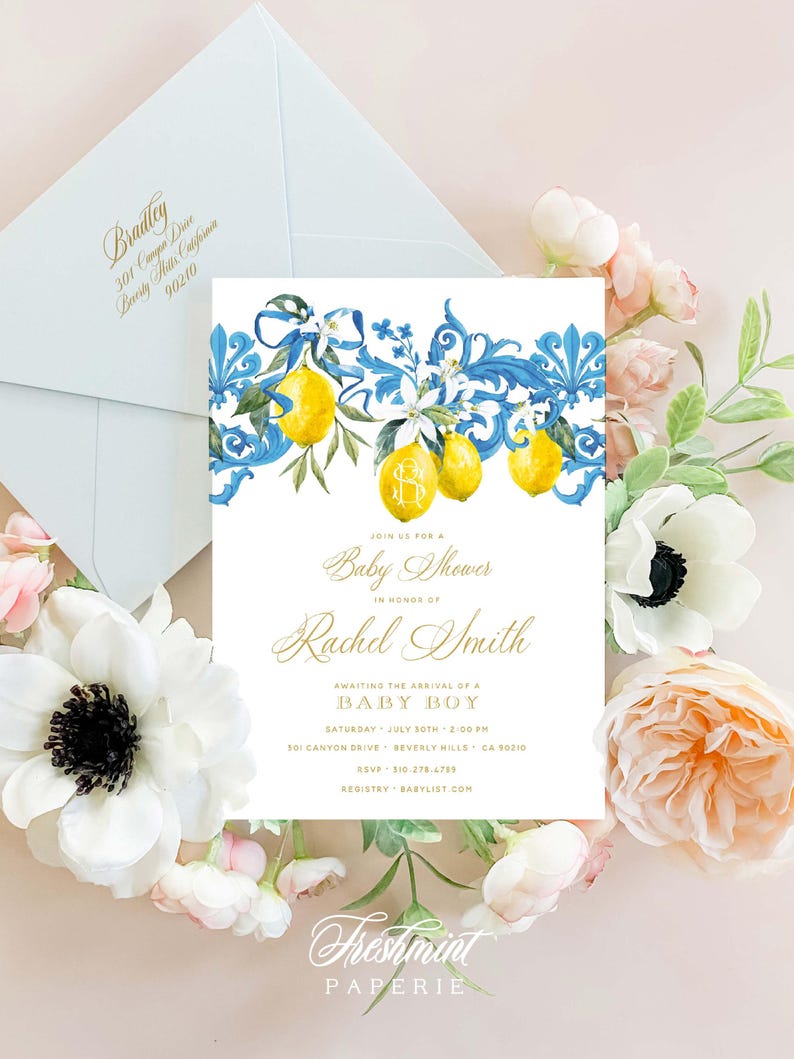 May include: A baby shower invitation with a blue and yellow lemon theme. The invitation features a watercolor illustration of lemons, blue ribbons, and floral details. The text on the invitation reads "Join us for a Baby Shower in honor of Rachel Smith Awaiting the arrival of a Baby Boy Saturday, July 8th, 2:00 PM 301 Canyon Drive, Beverly Hills, CA 90210 RSVP: 310-278-4799 Registry: Babylist.com Freshmint Paperie"
