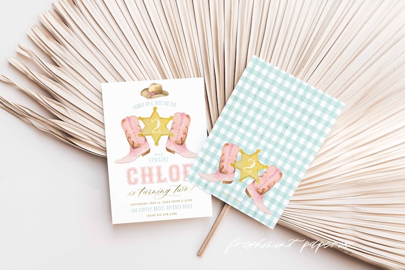 May include: A pink and gold invitation for a girl's second birthday party with a cowboy theme. The invitation features a pair of pink cowboy boots, a gold sheriff's star with the number 2, and a cowboy hat. The text on the invitation reads "Sample of Joy the 122 Cowgirl Chloe is turning two!"