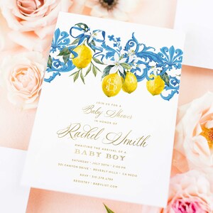 May include: A white baby shower invitation with a blue and gold floral design featuring lemons and a monogram. The invitation reads "Join us for a Baby Shower in honor of Rachel Smith Awaiting the arrival of a Baby Boy Saturday, July 30th, 2:00 PM 301 Canyon Drive, Beverly Hills, CA 90210 RSVP: 310-278.4789 Registry: Babylist.com"