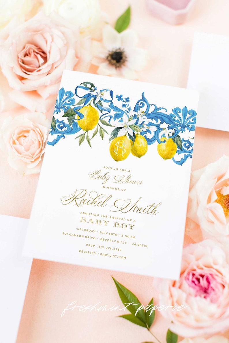 May include: A white baby shower invitation with a blue and gold floral design featuring lemons and a monogram. The invitation reads "Join us for a Baby Shower in honor of Rachel Smith Awaiting the arrival of a Baby Boy Saturday, July 30th, 2:00 PM 301 Canyon Drive, Beverly Hills, CA 90210 RSVP: 310-278.4789 Registry: Babylist.com"