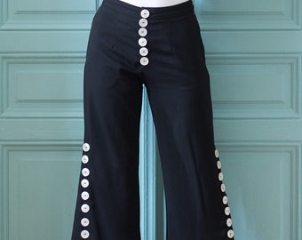 Flared trousers with shiny button