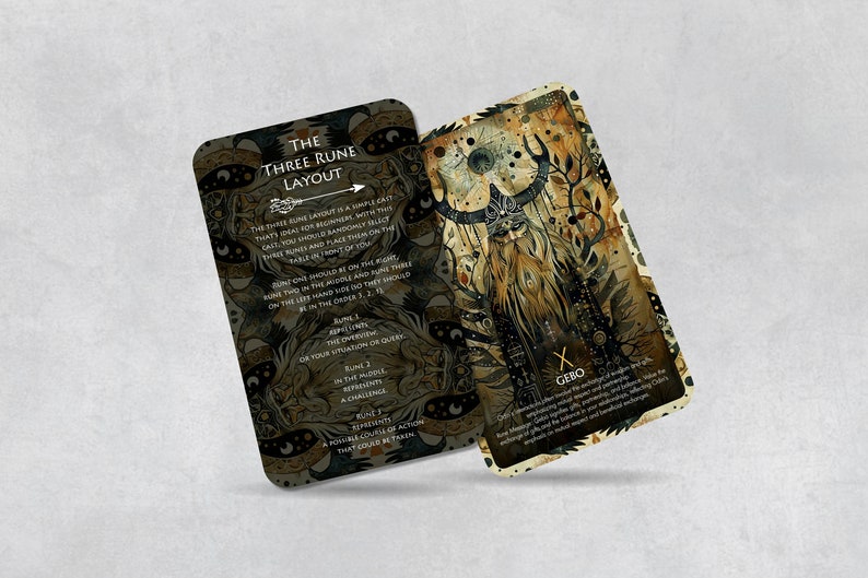 May include: Two cards with a gold and black design. The card on the left has instructions for a three rune layout. The card on the right has a rune symbol and the word "Gebo".