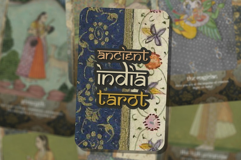 May include: A close-up of a tarot card with a blue and white floral design. The card has the text "ancient india tarot" in gold lettering.