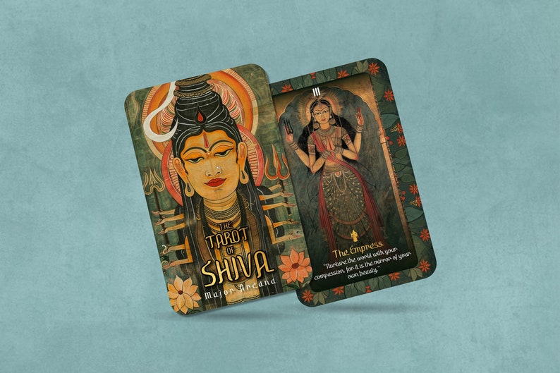 May include: Two tarot cards from The Tarot of Shiva deck. The first card shows a colorful illustration of Shiva, a Hindu deity. The second card shows a colorful illustration of The Empress, a tarot card. The text on the cards reads "The Tarot of Shiva" and "The Empress".