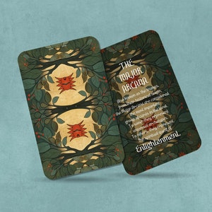 May include: A tarot card with a green, gold, and red design. The card features a stylized tree with a red bird on each side. The text on the card reads "THE MAJOR ARCANA. Also known as the trumps, these cards are the strongest from their heliacal union. The Major Arcana are considered the most important group of cards in the tarot. To some they represent universal archetypes. To others, they represent the spiritual quest of Enlightenment."