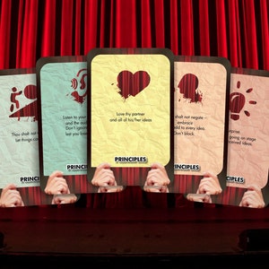May include: Five cards with different coloured backgrounds and illustrations. Each card has the word "PRINCIPLES" printed on it. The cards have the following text: "Thou shall not let things continue", "Listen to your gut and the audience. Don't ignore lest you lose", "Love thy partner and all of his/her ideas", "Thou shall not negate - embrace add to every idea. Don't block", "Surprise going on stage with received ideas."